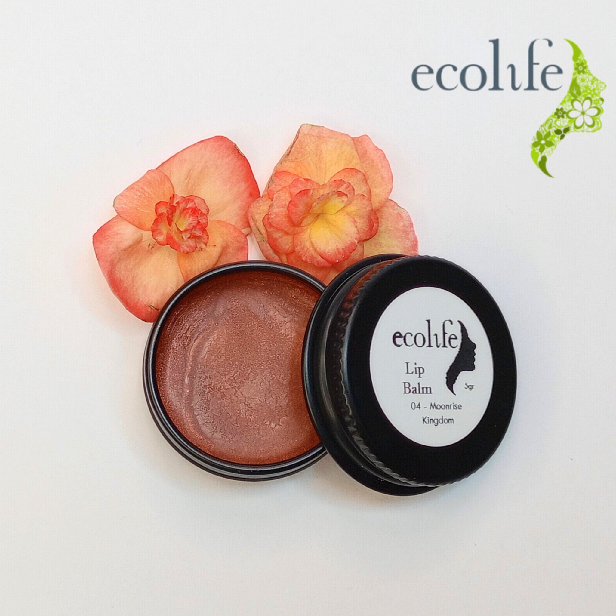 Lip balm in black tin with Ecolife Cosmetics label, brown color, and flowers