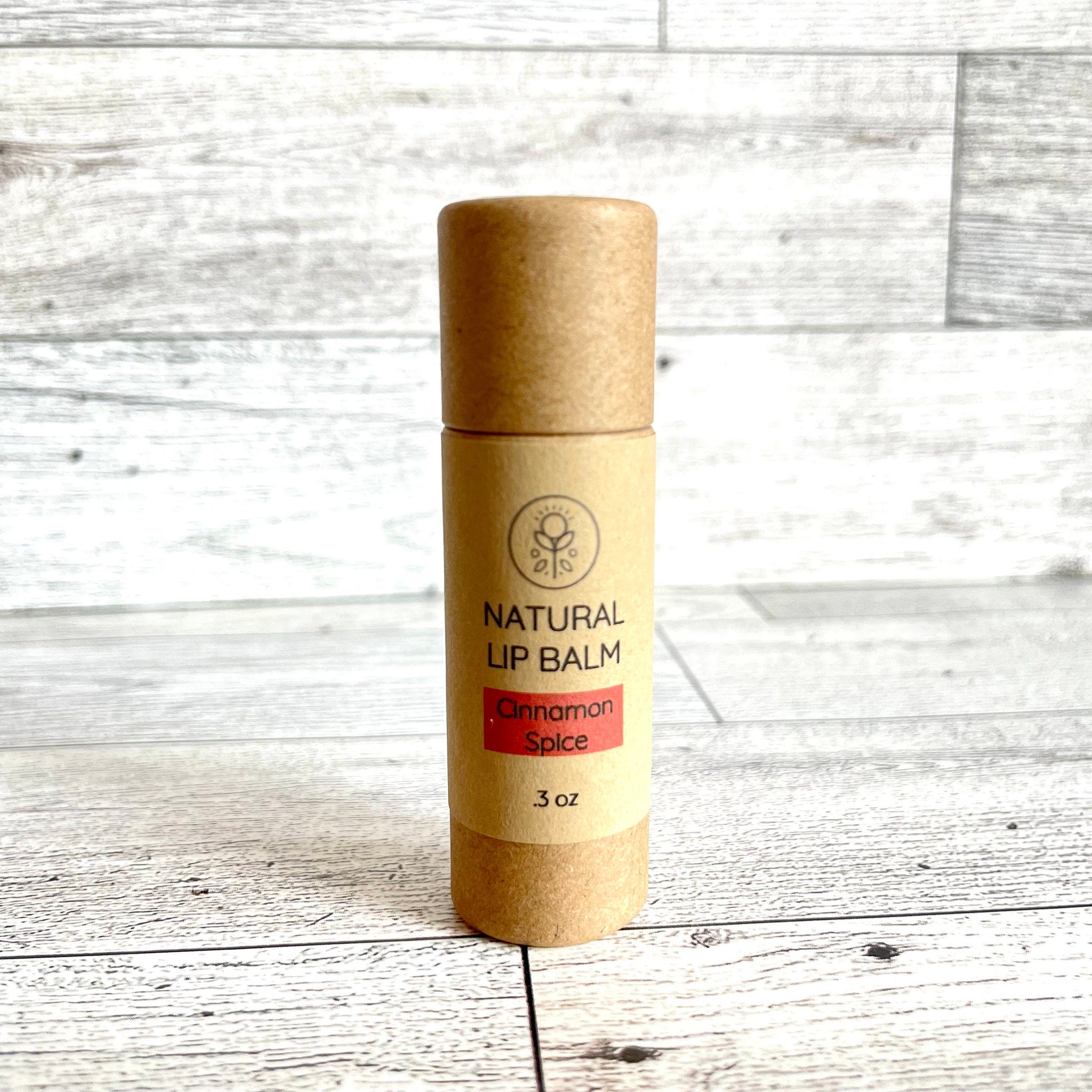 Natural lip balm in brown cardboard tube with red Cinnamon Spice label, Kind Home & Beauty Co.