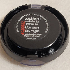 Close-up of fingertips applying shimmery blue and silver eyeshadow duo to eyelid crease
