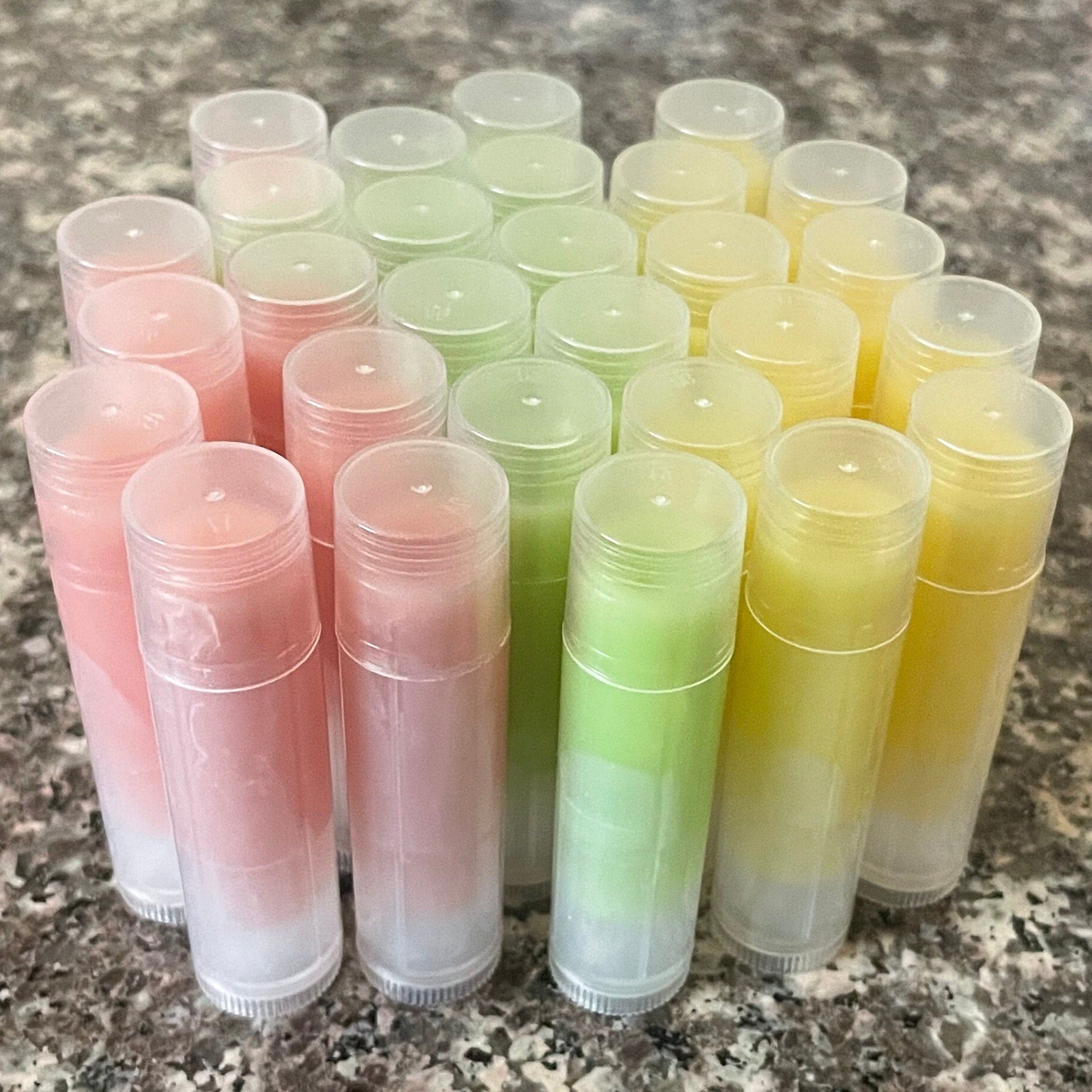 Lip balm tubes in various colors, clear plastic tubes, and colorful balm inside