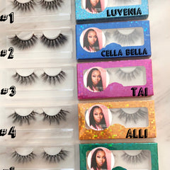 False eyelashes with black synthetic fibers, in clear plastic packaging, with LUVENIA text on blue glitter box