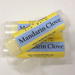 Lip balm tubes with yellow and blue labels, clear plastic, and Mandarin Clove text by Lee's Bees