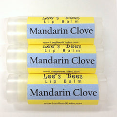 Lip balm tubes with yellow and blue labels, "Lee's Bees" brand, "Mandarin Clove" text, clear tubes