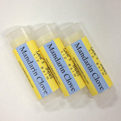 Lip balm tubes with yellow and blue labels, clear plastic container, Lees Bees brand