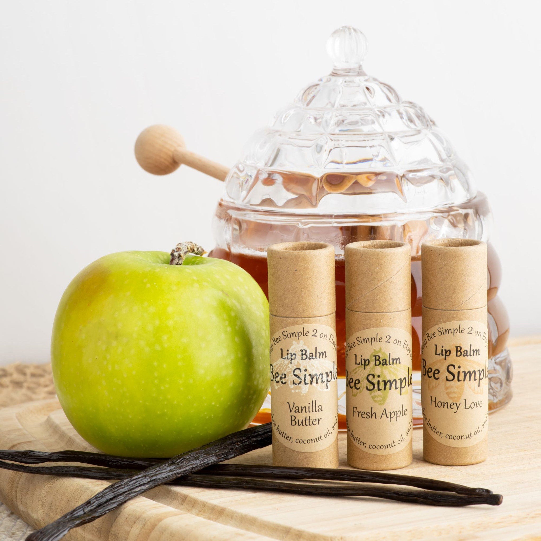 Lip balm set with Bee Simple brand, brown paper tubes, and apple and honey display