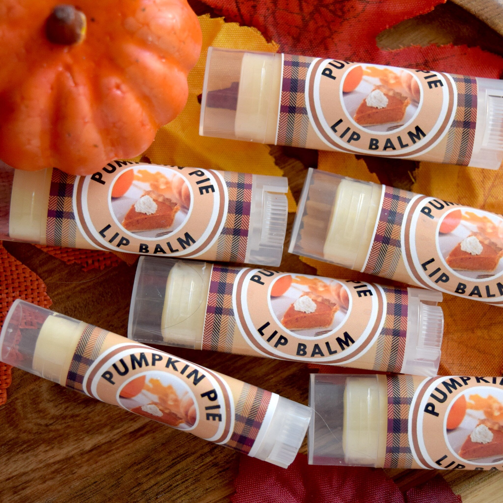 Lip balm tubes with pumpkin pie labels, plaid pattern, clear plastic casing