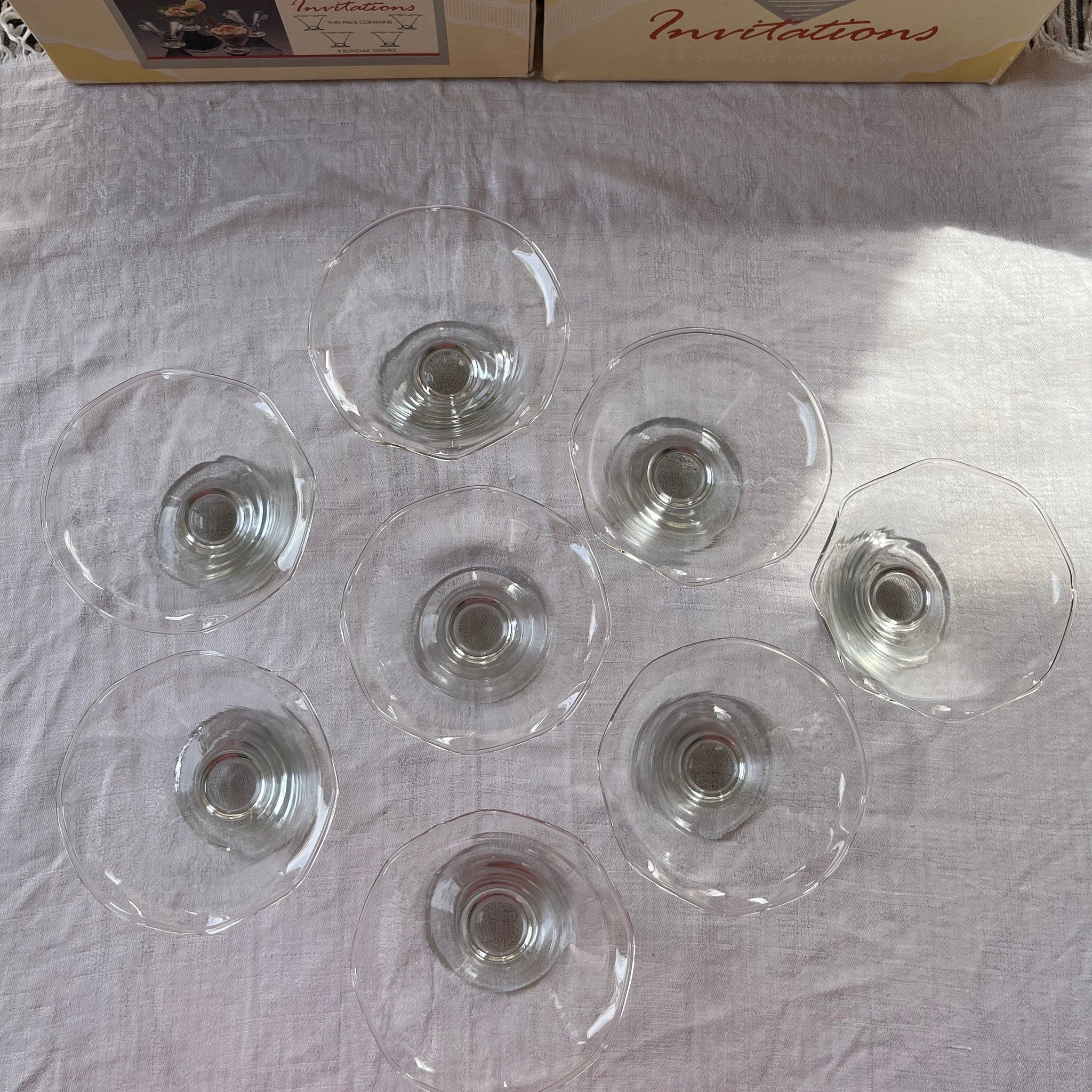 Glass sundae dishes, clear glass, round bowl, stemmed base, on white cloth