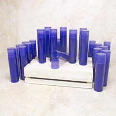 Lip balm tubes in blue plastic with a white wooden crate background