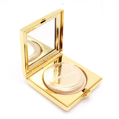 Powder compact with gold case, mirror, and Estee Lauder text visible