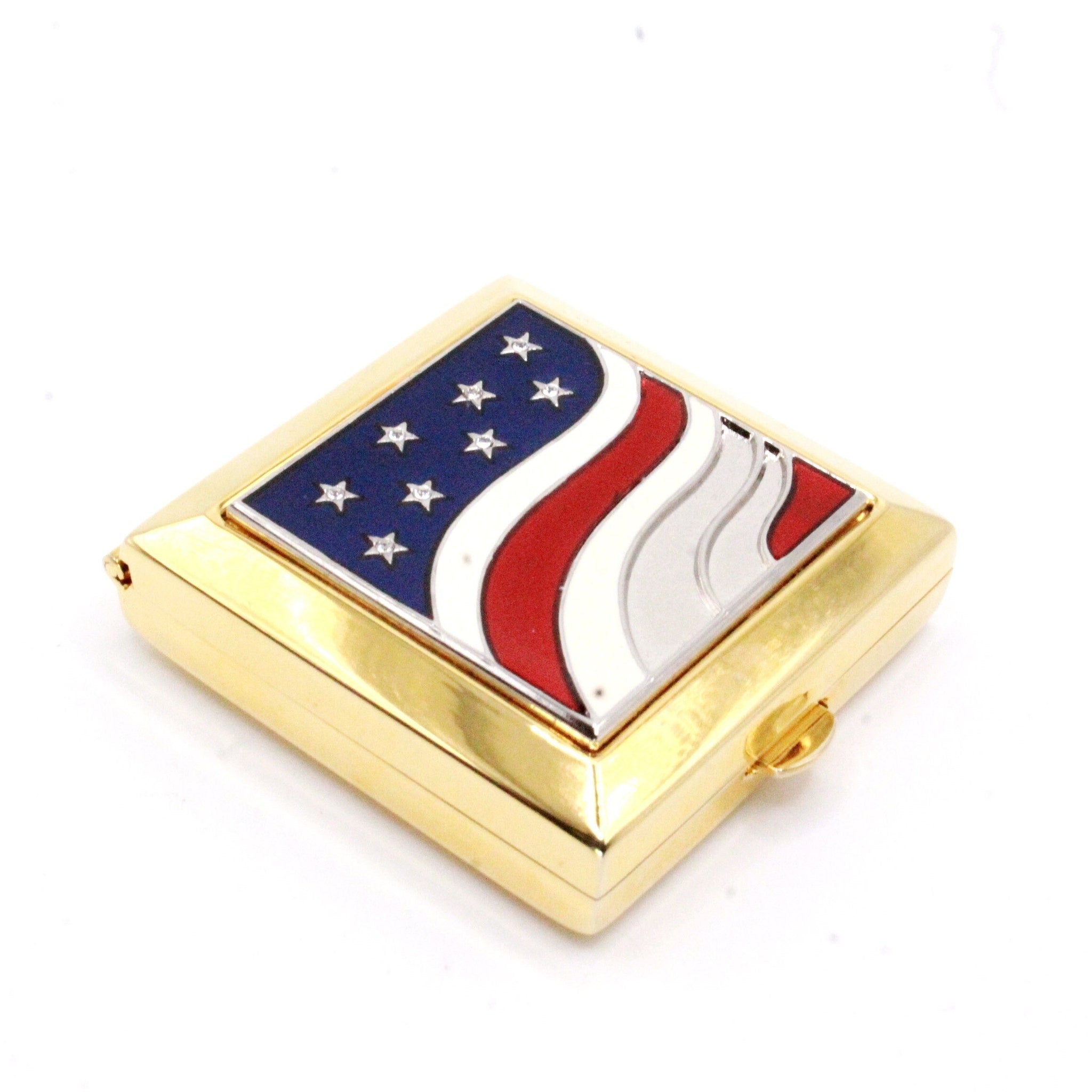 Compact case with American flag design, gold metal, blue, red, and white enamel detail