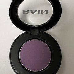 Close-up of matte amethyst eyeshadow pan showing rich purple pigment and smooth pressed texture