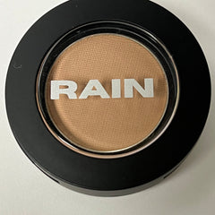 Square compact of suede matte eye shadow in warm taupe shade with smooth texture and minimalist packaging