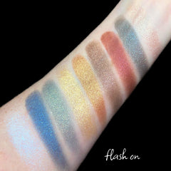 Side view of Vegan Blue Moon Eyeshadow Palette showing six vibrant blue shades in circular pans with silver compact