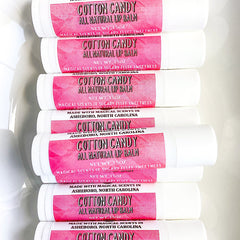 Lip balm tubes with pink label, white tube, and Cotton Candy text visible