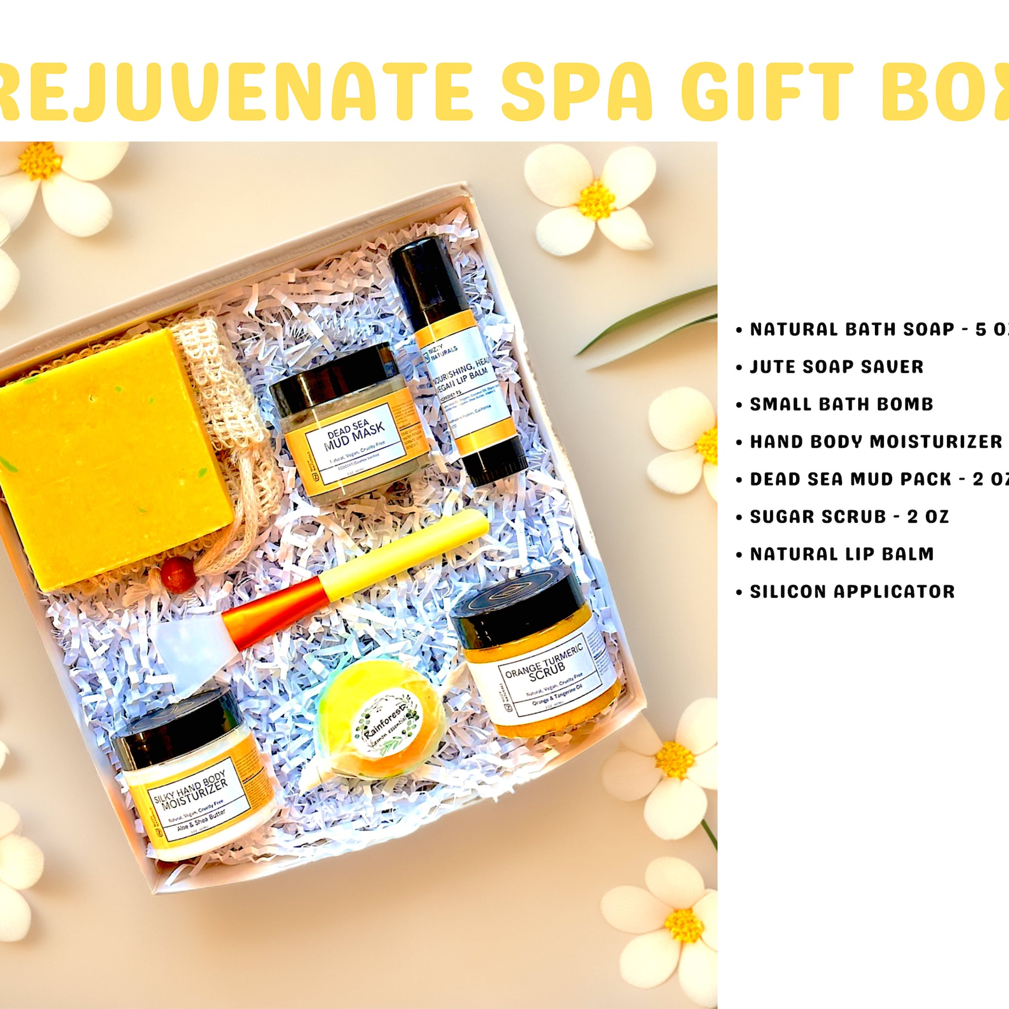 Spa gift box with yellow products, white paper filler, and white flowers on a light background