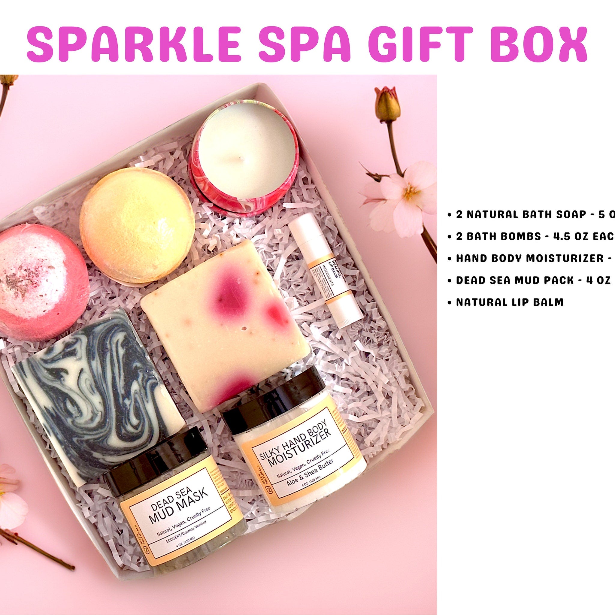 Spa gift box with pink, yellow, and blue soaps, candle, and lip balm in a white box with paper filler