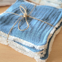 Close-up of soft bamboo and cotton gauze wipes stacked in a neutral-toned package with textured surface details