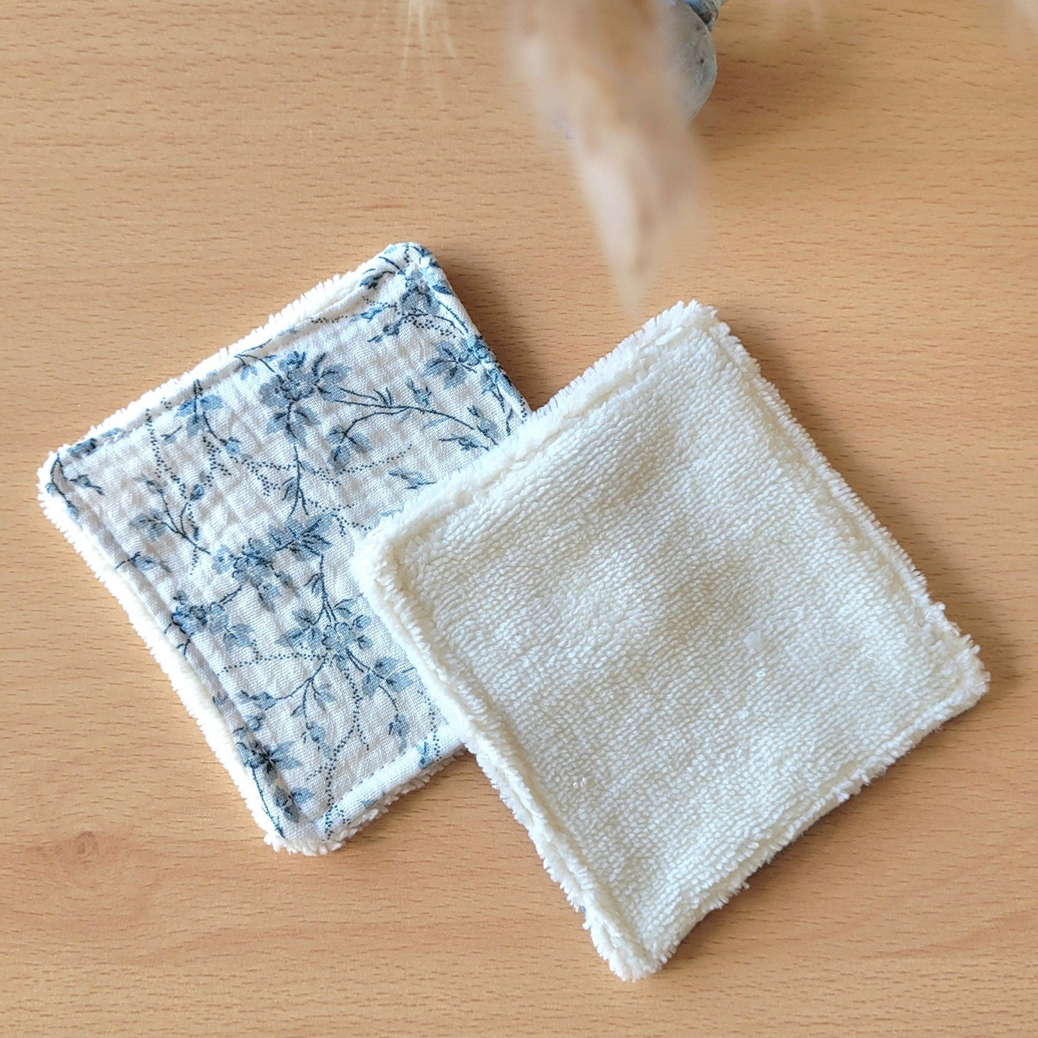 Stack of premium soft bamboo and cotton gauze wipes in minimalist white packaging with green accents