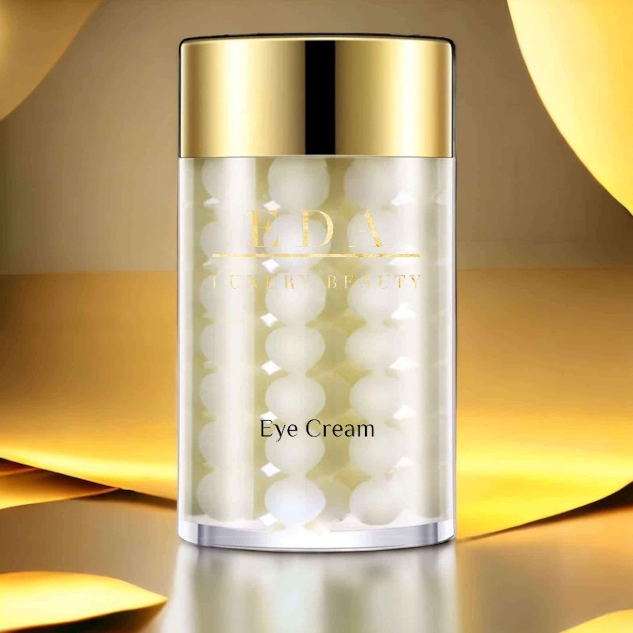 Eye cream bottle with gold cap and Eda Luxury Beauty text, filled with white spheres