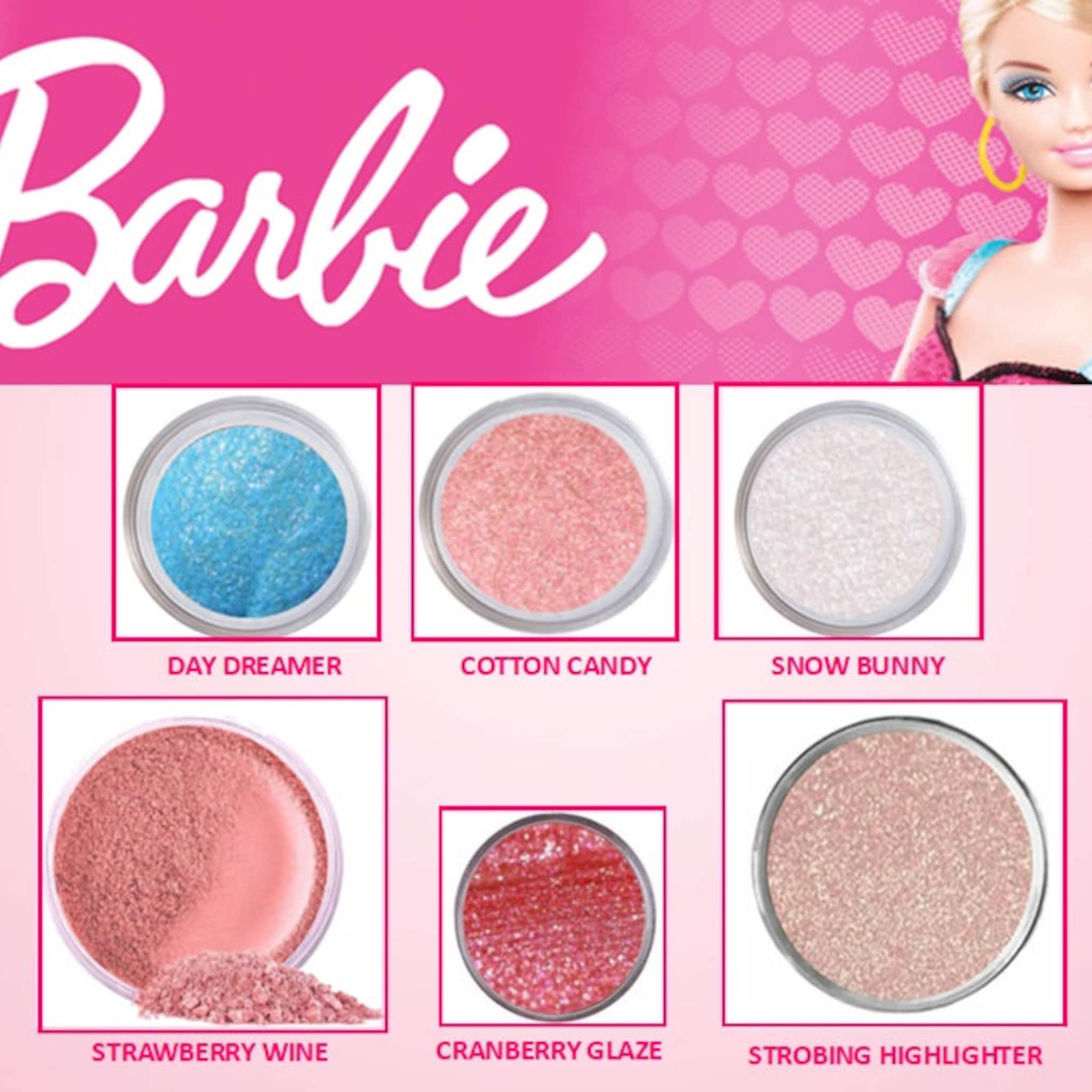 Eye shadow kit with pink Barbie logo, sparkly eyeshadow colors, and a Barbie doll image