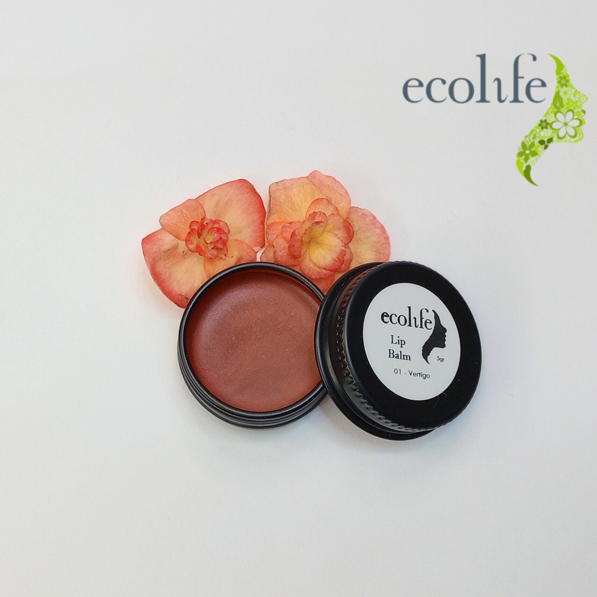 Lip balm in black container with Ecolife Cosmetics branding, and brown lip balm color, with flowers