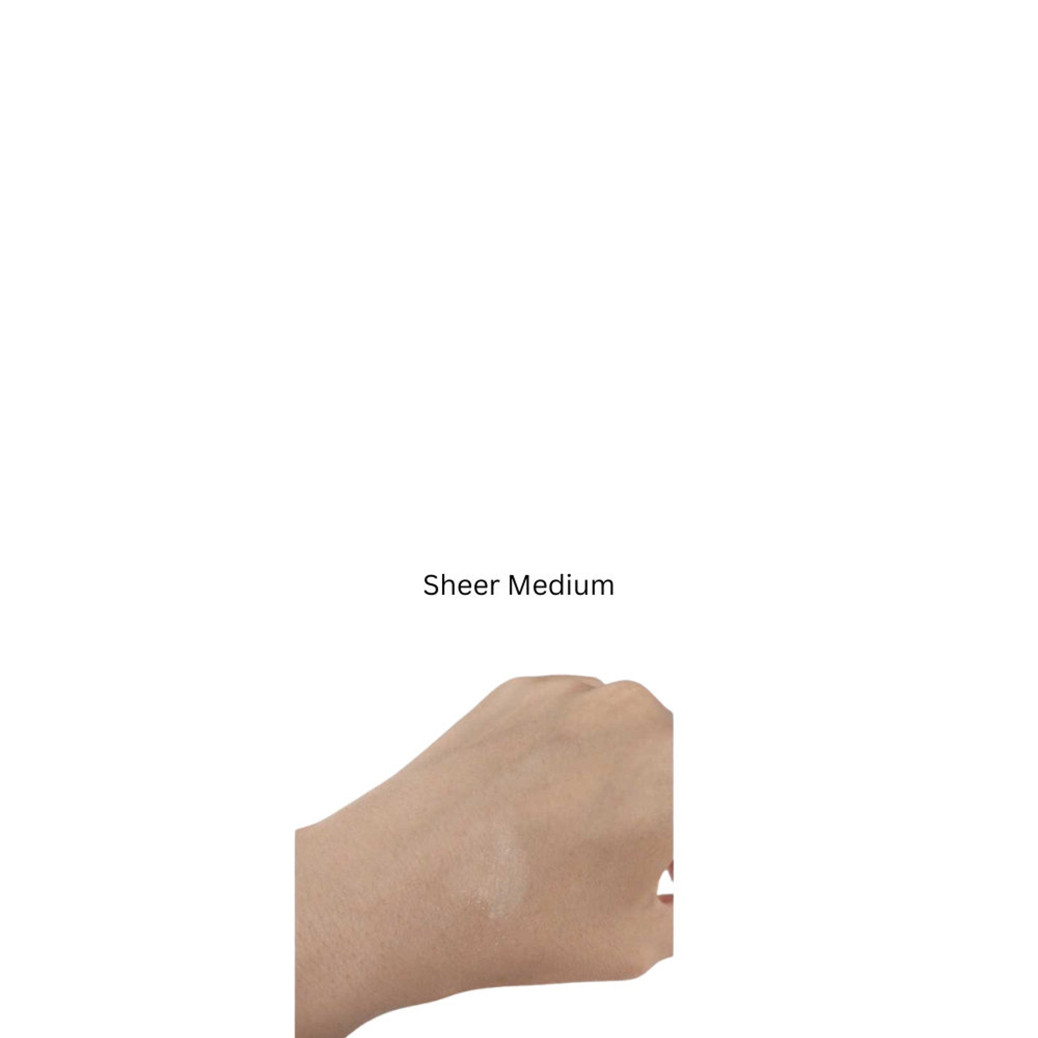Hand with applied sheer medium, skin-toned, with visible application on the skin.