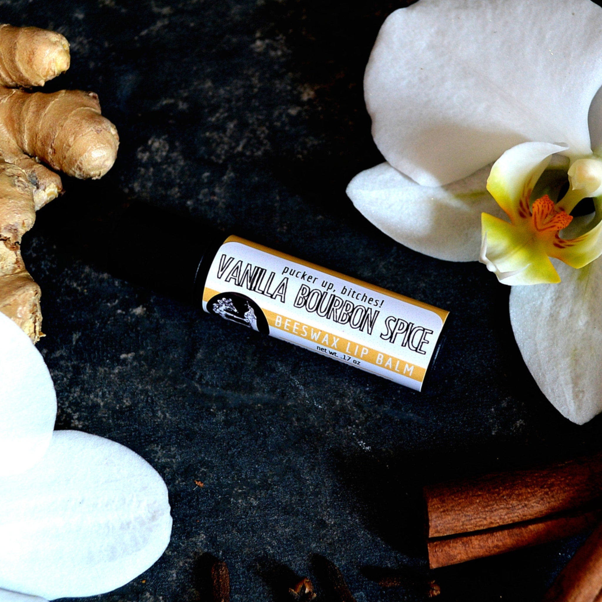 Lip balm tube with black and yellow label, white text, and "Vanilla Bourbon Spice" flavor