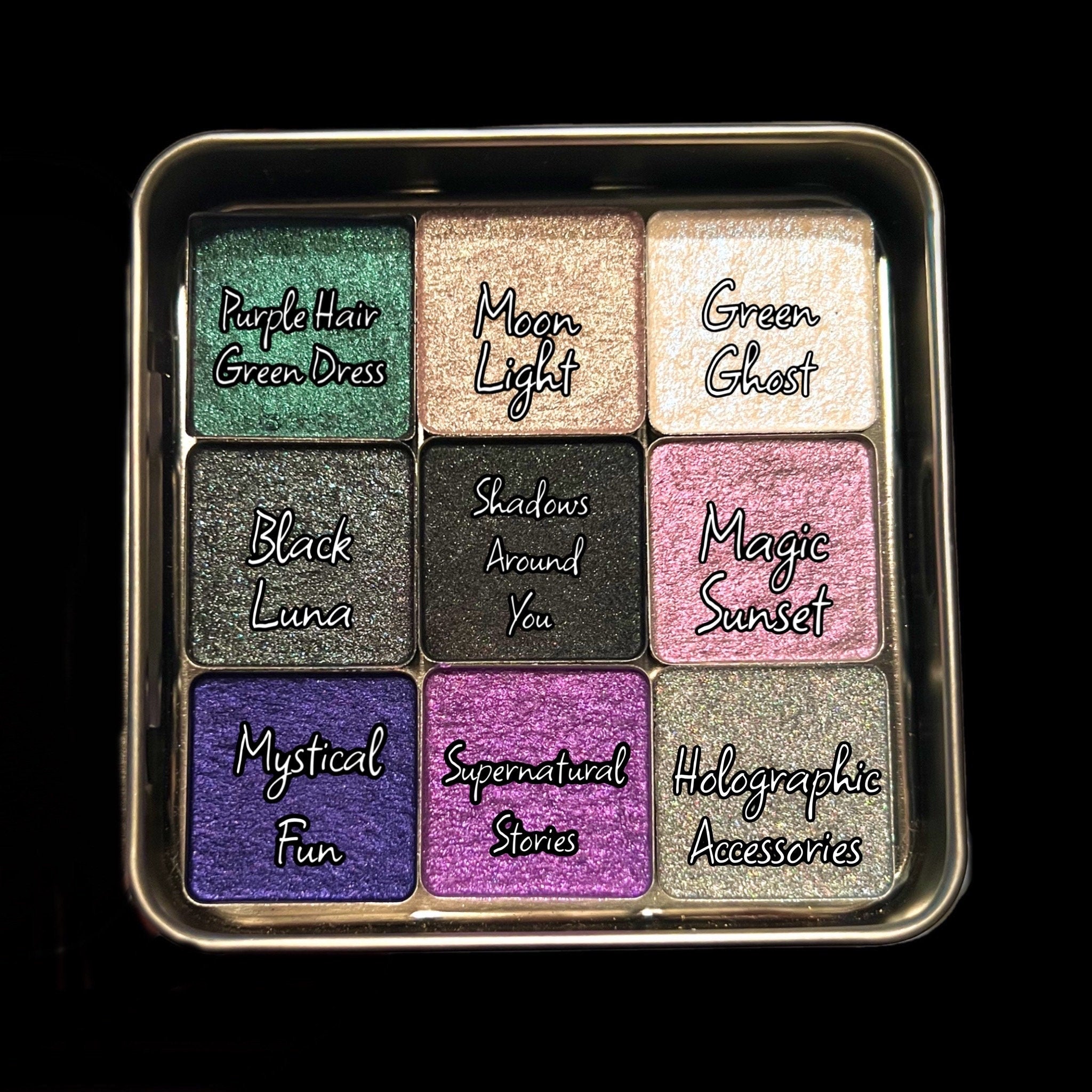 Eyeshadow palette with multiple colors, glittery textures, and text labels for each shade