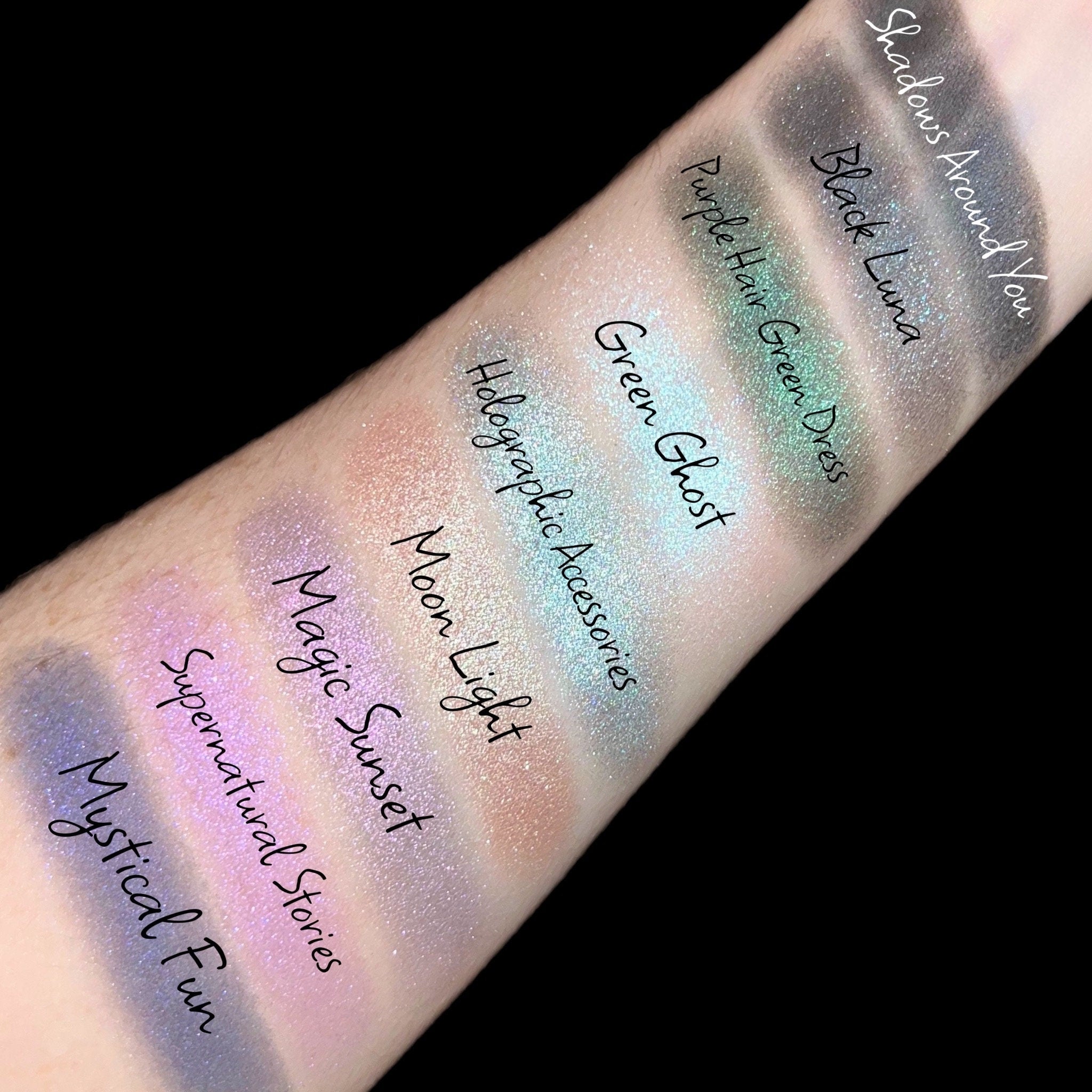 Eyeshadow swatches, various colors, glittery finish, arm display