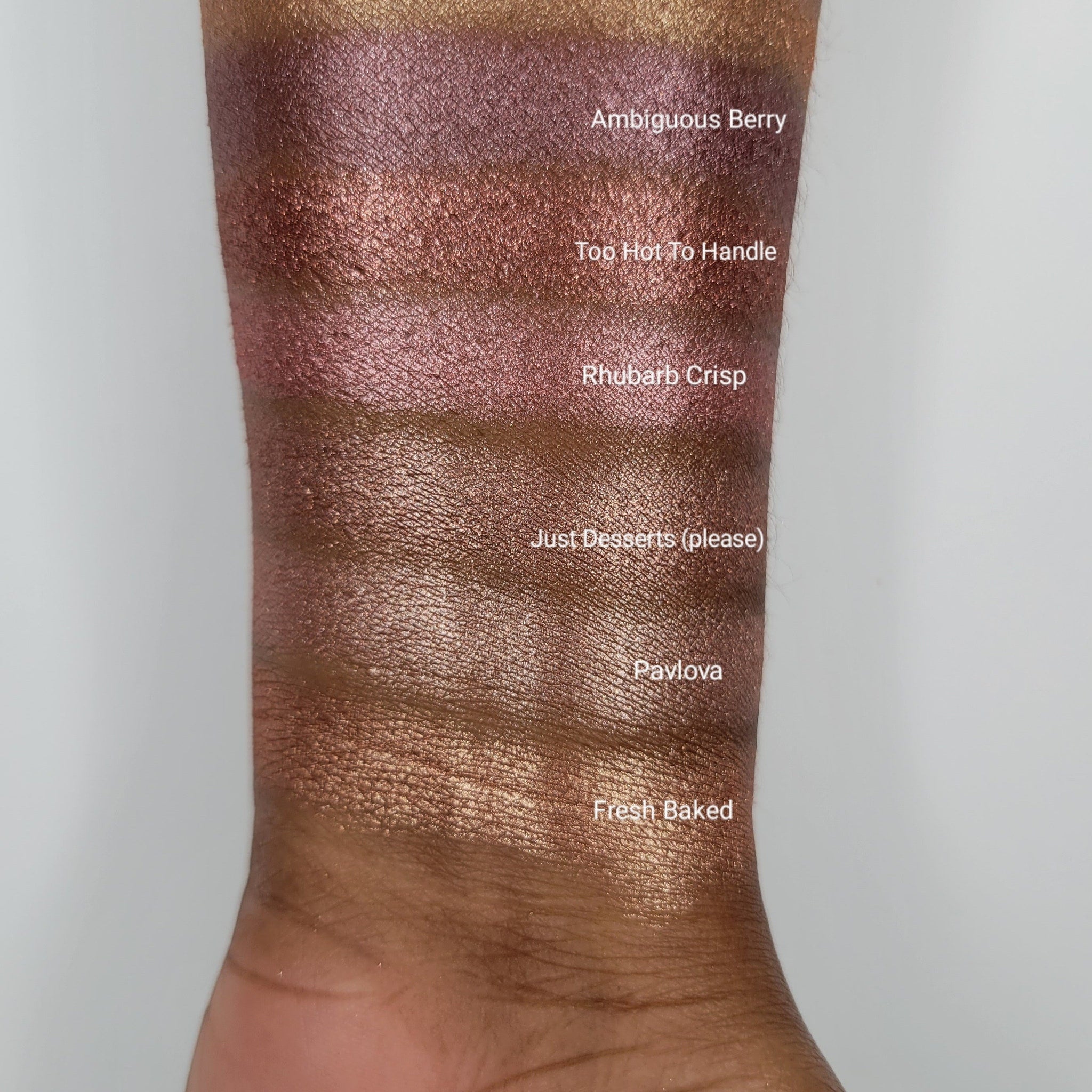 Close-up of beige blush shimmer eyeshadow pan showing finely milled powder texture and warm golden undertones