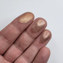 Side view of shimmer eyeshadow bundle showing six pans in pink, brown, and red hues with reflective finish