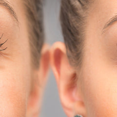 Human skin, light peach tone, close-up of face and ear, showing texture and detail