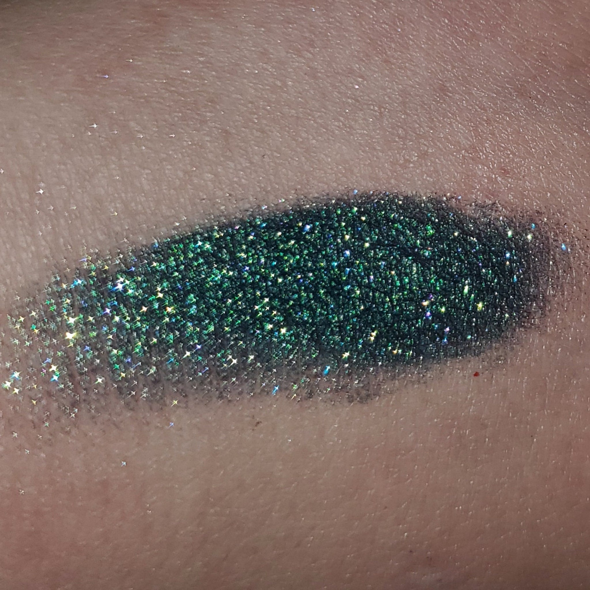 Side view of eye shadow palette showing textured powder surface and compact case design