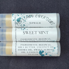 Lip balm tubes with white labels, teal accents, and Copeland Creations text