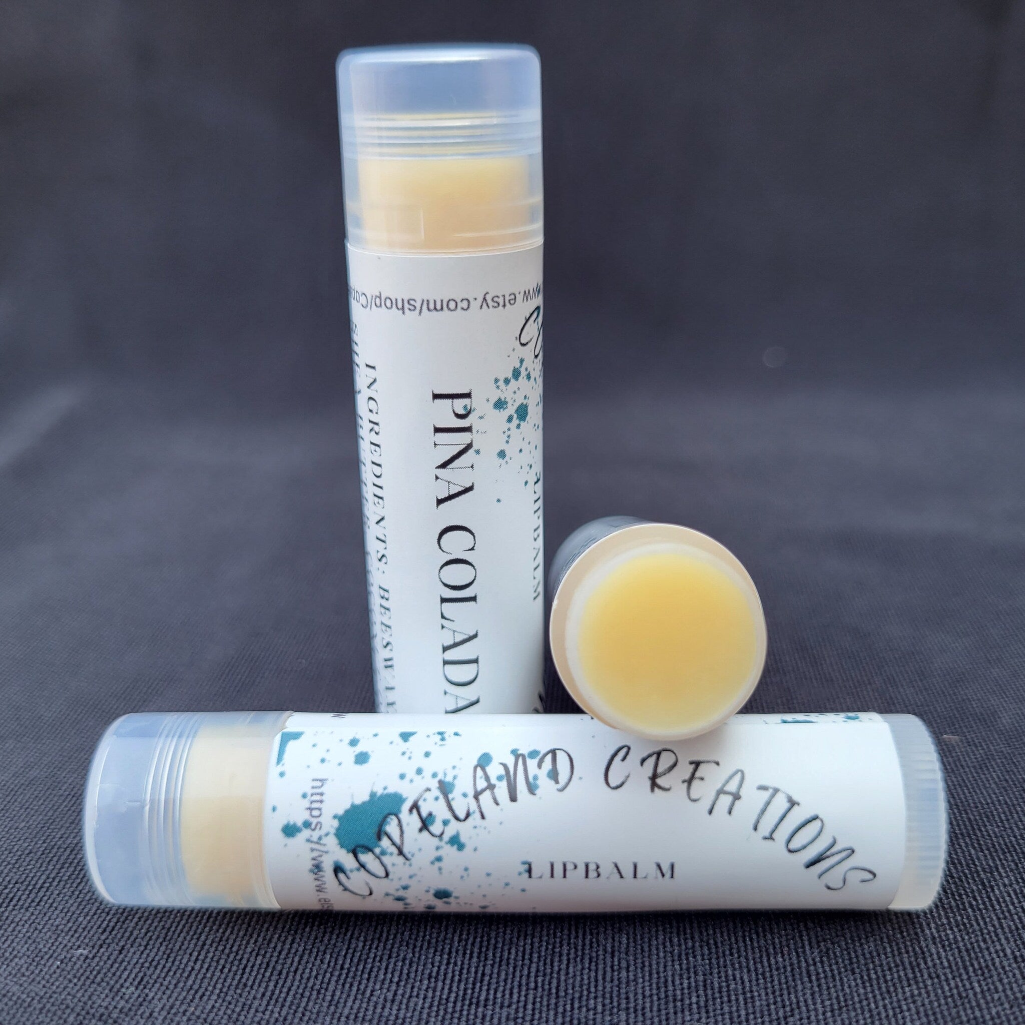 Lip balm tubes with white labels, yellow balm, and Copeland Creations text