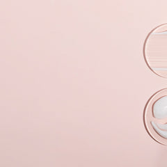 Skincare product samples on pink background, two circular shapes with light and white textures