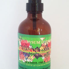 Brown glass spray bottle with black pump and green label, GardenOfEssences brand