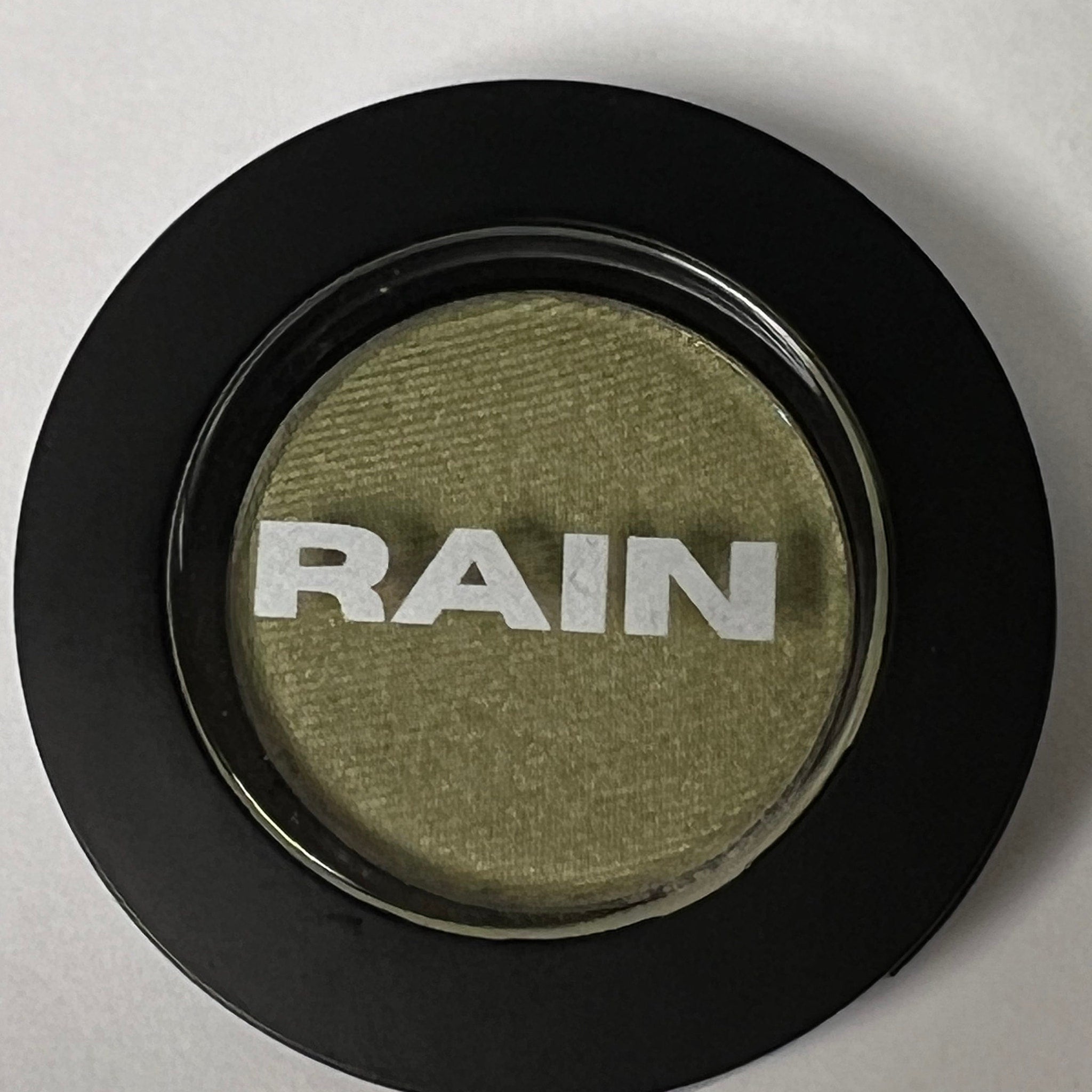 Shimmering golden sage eye shadow in compact with reflective metallic casing