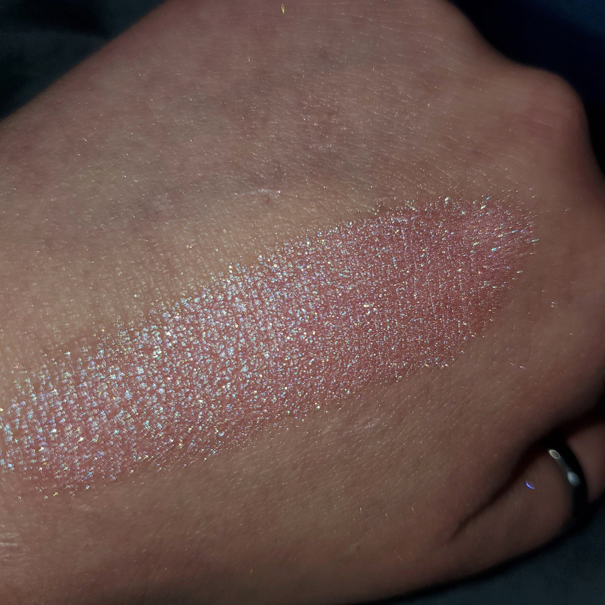 Close-up of shimmering bronze eye shadow palette with smooth, blendable powder texture