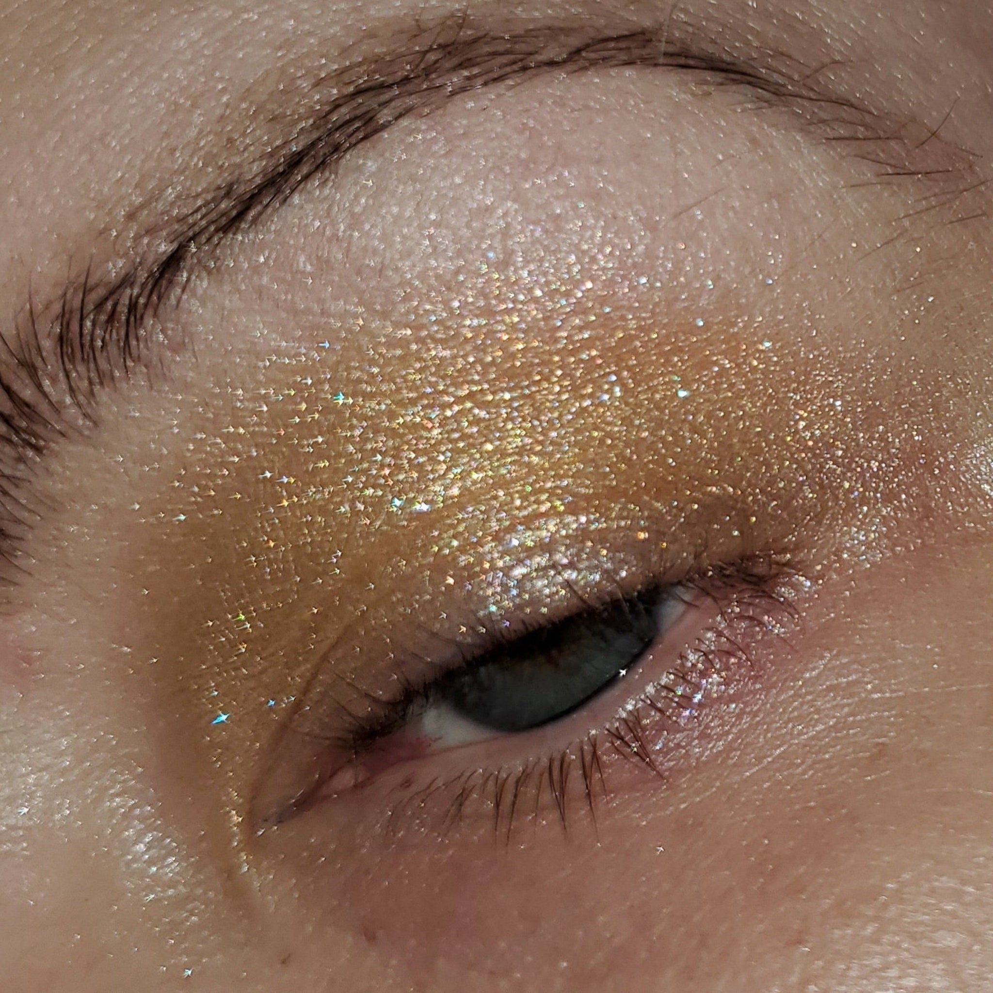Close-up of Chareth Cutestory Eye Shadow palette showing shimmering bronze and taupe shades with smooth, blendable texture