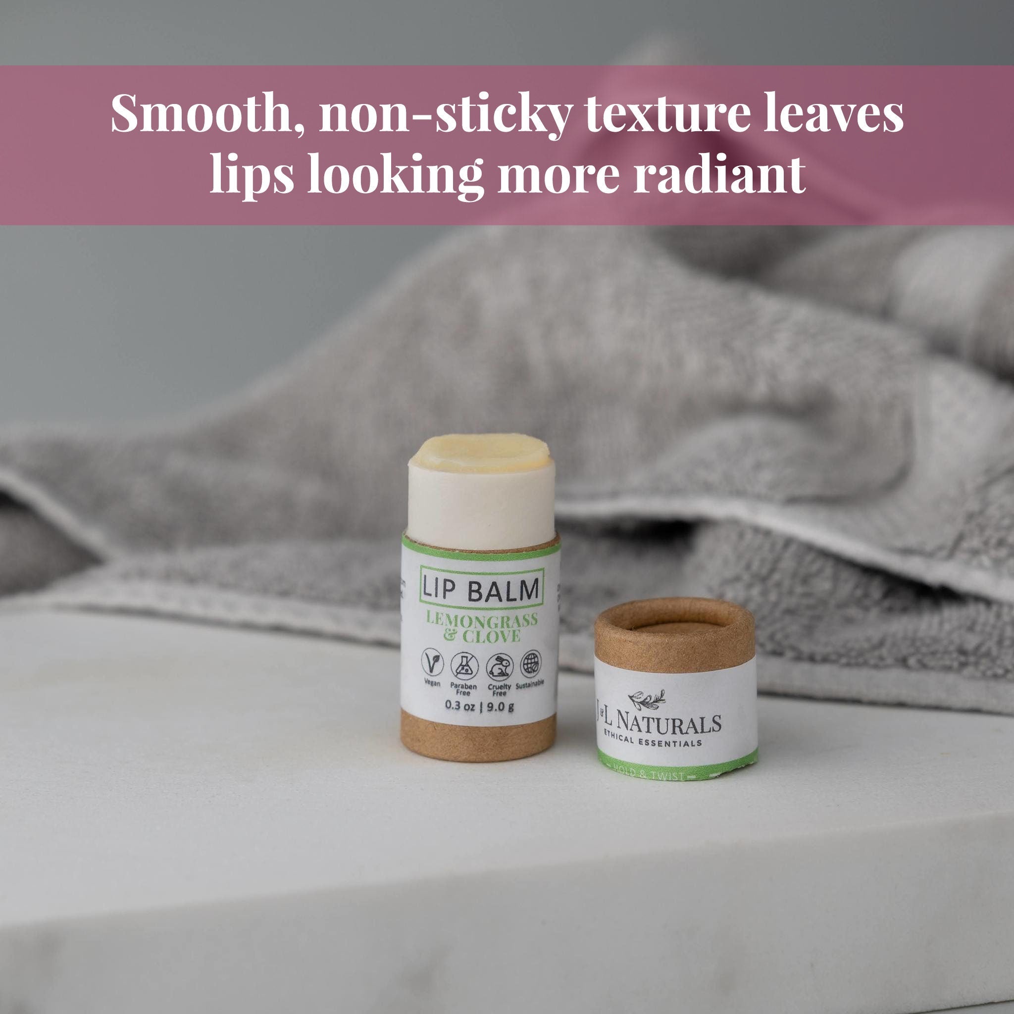 Lip balm, white and brown tube, jnlnaturals brand, on a white surface with a gray towel in background