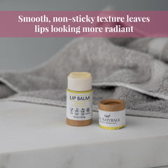 Lip balm in white and brown tubes, with JN Naturals branding, on a white surface