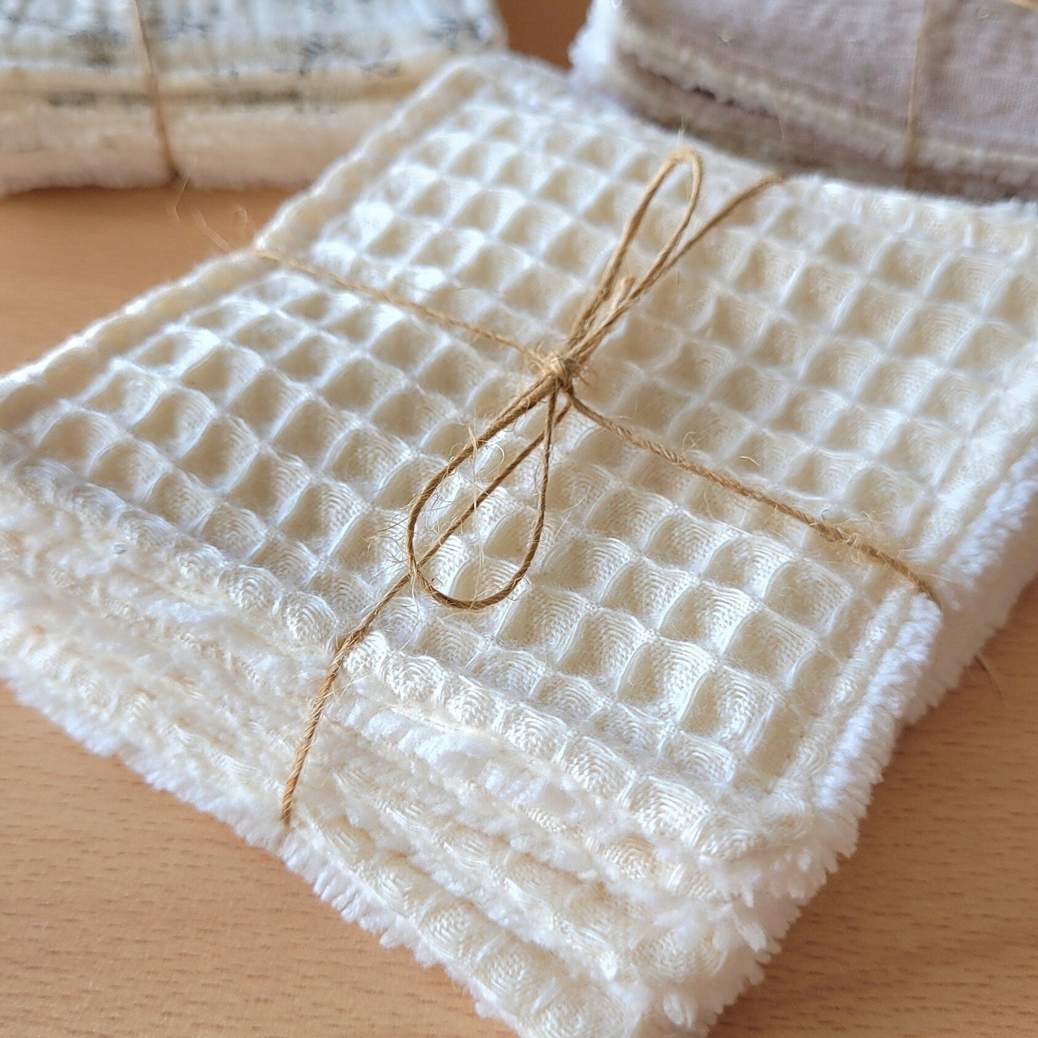 Gentle bamboo makeup wipe removing mascara from skin with eco-friendly cotton gauze texture