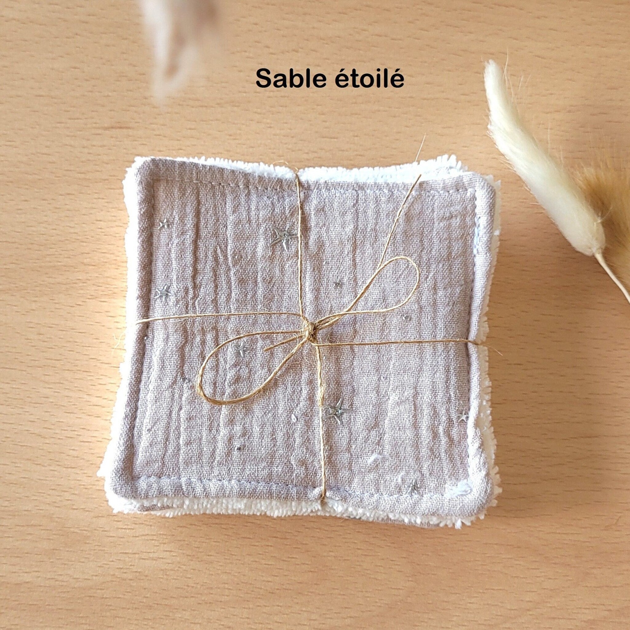 Close-up of soft eco-friendly cotton gauze and bamboo wipes in neutral tones, showing delicate texture for gentle skincare