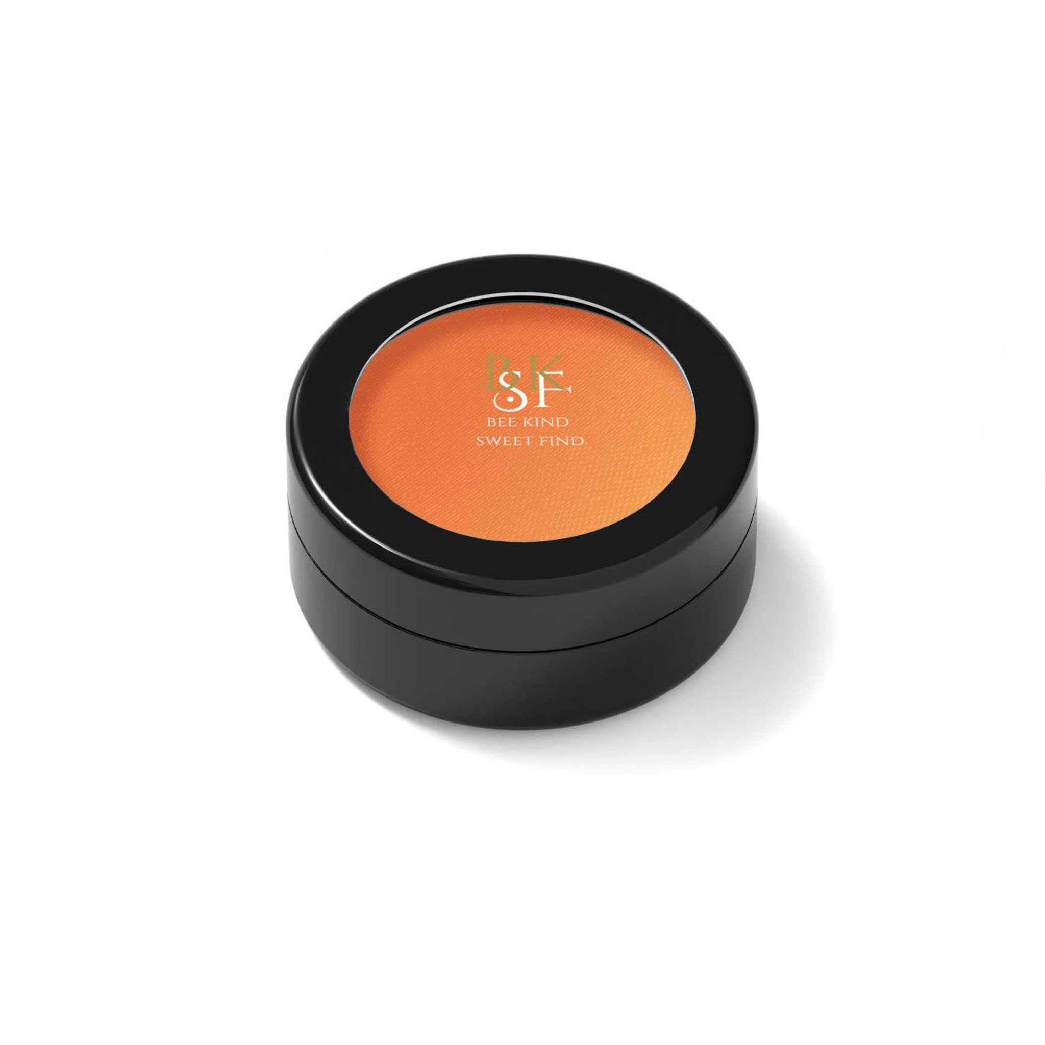 Orange eyeshadow compact with black case, BKSF branding visible, round shape