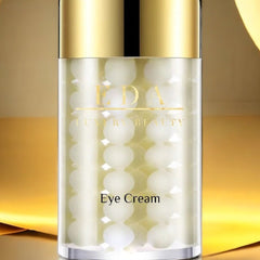 Eye cream bottle with gold cap and EDA LUXURY BEAUTY text, white spheres inside