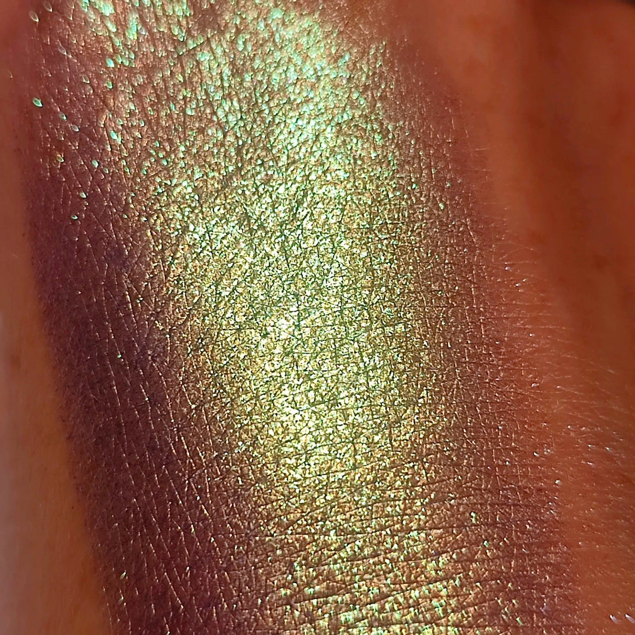 Close-up of deep blue-violet pressed powder eyeshadow with subtle shimmer in compact palette