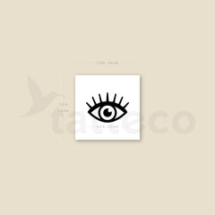 Close-up of three sleek metallic eye tattoo pens with precision tips, arranged on minimalist marble surface