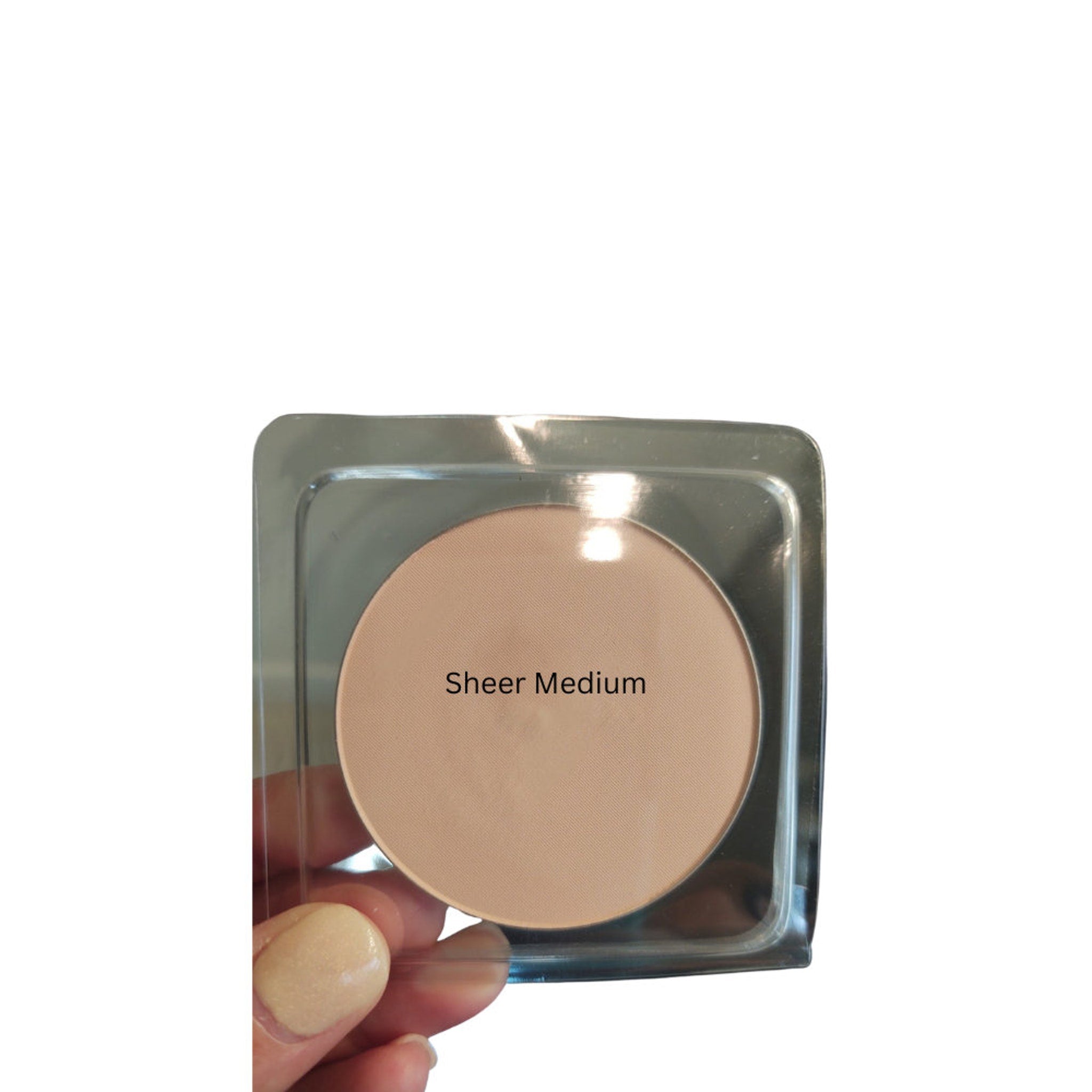 Powder compact with beige powder, clear plastic case, and "Sheer Medium" text
