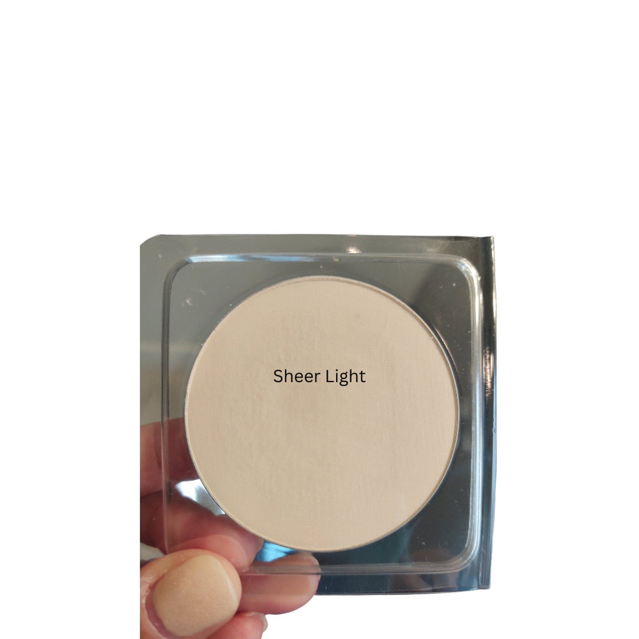 Powder compact with beige color and "Sheer Light" text in a clear plastic case